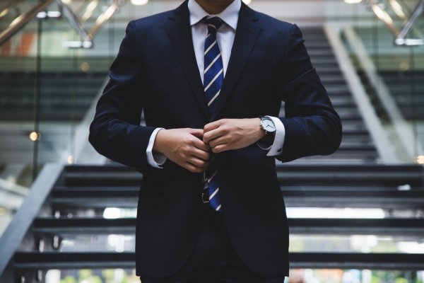 a lawyer in a blue suit with a striped tie 